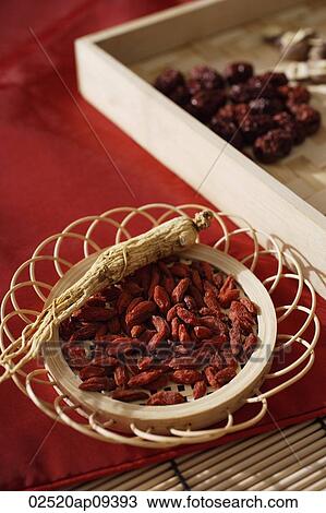 Stock Image - Still life of wolf berries, ginseng and red dates. Fotosearch