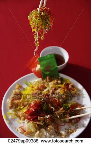 Tossing raw fish salad also known as "Yu Sheng" or "Lo Hei" View Large Photo Image Stock Photo - Tossing raw fish salad also known as "Yu Sheng" or "Lo Hei". Fotosearch