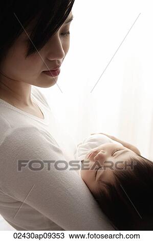 Woman holding sleeping baby View Large Photo Image Stock Image - Woman holding sleeping baby. Fotosearch