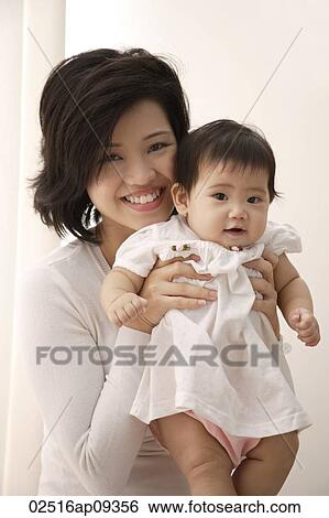 Stock Photograph - Young woman with baby girl. Fotosearch