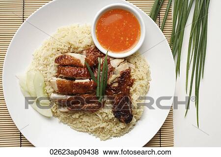 Stock Photo - chicken rice with chili sauce on the side on white plate. Fotosearch