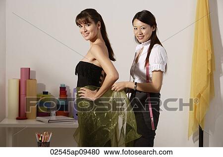 chinese fashion designer draping cloth around model's waist, taking measurements View Large Photo Image Stock Image - chinese fashion designer draping cloth around model's waist, taking measurements. Fotosearch