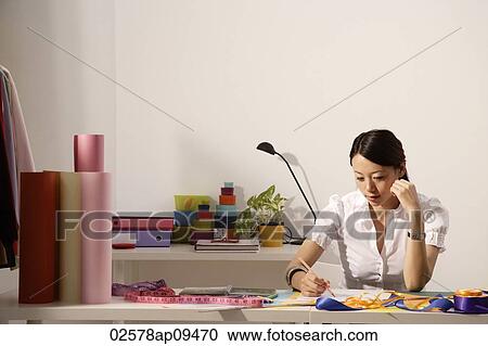 Chinese fashion designer sketching at work desk View Large Photo Image Stock Image - Chinese fashion designer sketching at work desk. Fotosearch