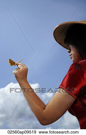 Chinese woman with conical hat holding a paper crane View Large Photo Image Stock Photo - Chinese woman with conical hat holding a paper crane. Fotosearch