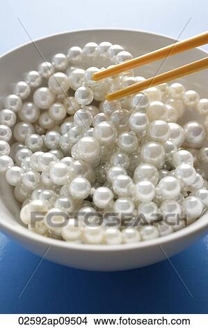 chopsticks picking a strand of pearls from a bowl View Large Photo Image Picture - chopsticks picking a strand of pearls from a bowl. Fotosearch