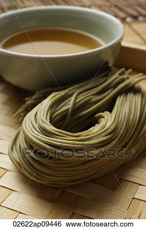Stock Photograph - cooked soba noodles with sauce on the side placed on bamboo tray closeup. Fotosearch