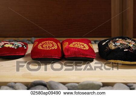 front view of red and black oriental slippers at door front View Large Photo Image Stock Image - front view of red and black oriental slippers at door front. Fotosearch