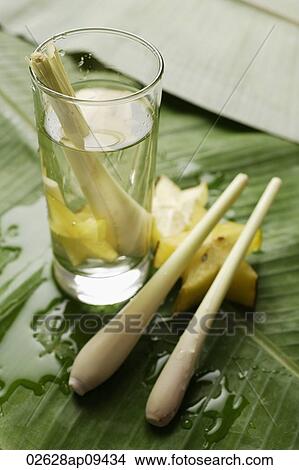 lemon grass stalk in glass of water with star fruits View Large Photo Image Picture - lemon grass stalk in glass of water with star fruits. Fotosearch