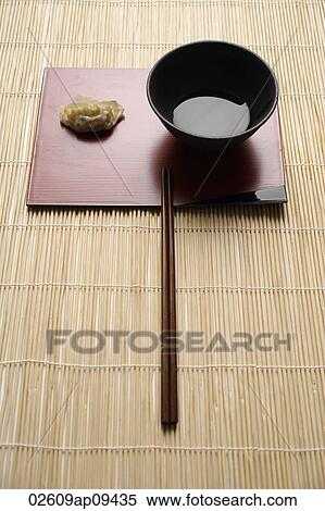 steam gyoza dumpling with sauce in bowl and chopstick on bamboo mat View Large Photo Image Stock Photography - steam gyoza dumpling with sauce in bowl and chopstick on bamboo mat. Fotosearch