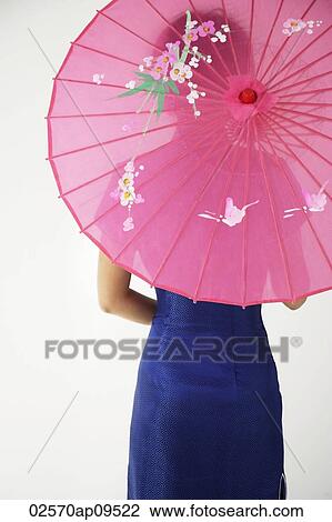 young Chinese woman in blue cheongsam holding pink umbrella View Large Photo Image Stock Image - young Chinese woman in blue cheongsam holding pink umbrella. Fotosearch