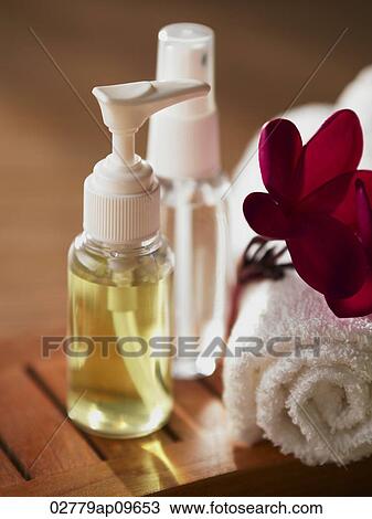bottle of lotion and rolled up towel View Large Photo Image Stock Image - bottle of lotion and rolled up towel. Fotosearch