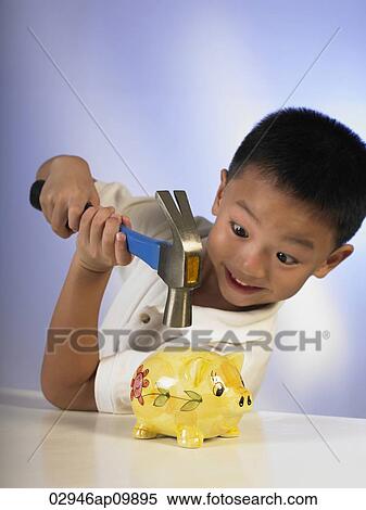 boy hitting a piggy bank with a hammer View Large Photo Image Stock Photography - boy hitting a piggy bank with a hammer. Fotosearch