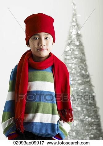 Stock Photo - boy in front of christmas tree. Fotosearch