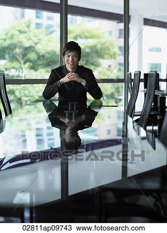 business man sitting at head of table View Large Photo Image Stock Image - business man sitting at head of table. Fotosearch