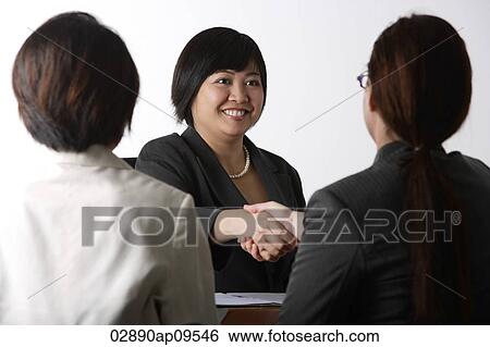 Stock Photograph - business woman shaking hands. Fotosearch