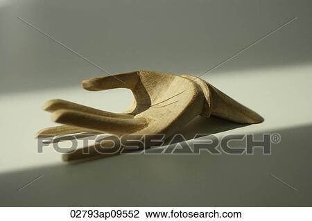 Stock Image - carved buddhist wooden hand. Fotosearch