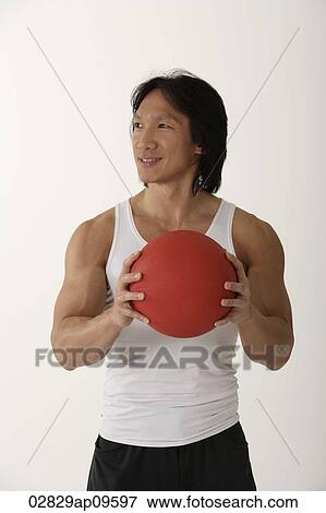 Chinese man holding medicine ball View Large Photo Image Stock Photo - Chinese man holding medicine ball. Fotosearch