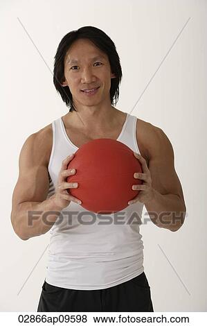 Chinese man holding medicine ball View Large Photo Image Stock Photo - Chinese man holding medicine ball. Fotosearch