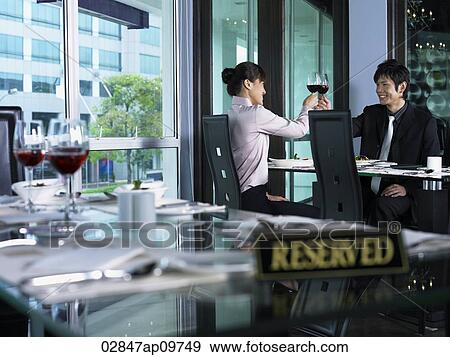 couple toasting each other in restaurant View Large Photo Image Stock Photo - couple toasting each other in restaurant. Fotosearch