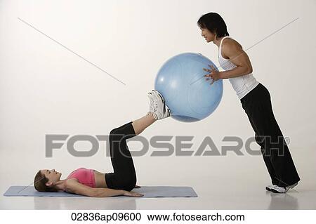 Couple working out with exercise ball View Large Photo Image Stock Image - Couple working out with exercise ball. Fotosearch