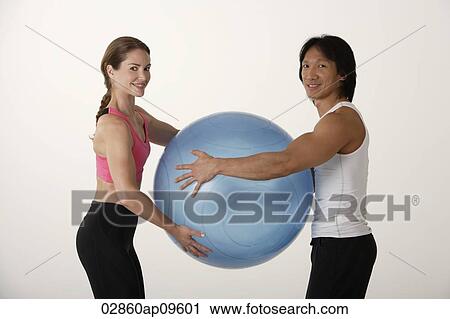 Couple working out with exercise ball View Large Photo Image Stock Image - Couple working out with exercise ball. Fotosearch