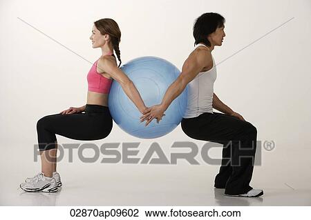Couple working out with exercise ball View Large Photo Image Stock Image - Couple working out with exercise ball. Fotosearch