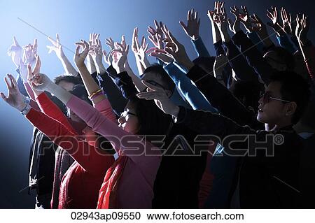 Stock Image - crowd cheering with hands raised. Fotosearch