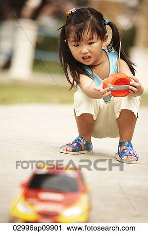 girl playing with a remote car outside View Large Photo Image Stock Image - girl playing with a remote car outside. Fotosearch