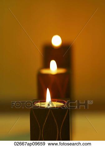 lit up candles in a row View Large Photo Image Stock Photo - lit up candles in a row. Fotosearch