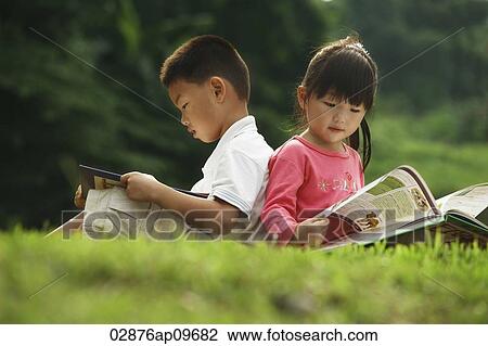 little boy and girl reading a book outdoors View Large Photo Image Stock Image - little boy and girl reading a book outdoors. Fotosearch