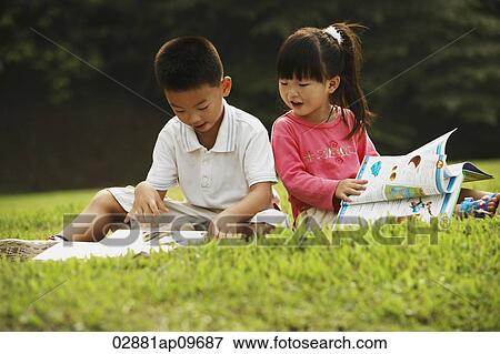 little boy and girl reading a book outdoors View Large Photo Image Stock Photo - little boy and girl reading a book outdoors. Fotosearch