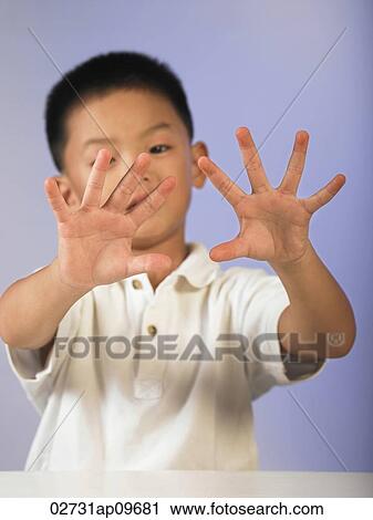 Stock Image - little boy counting with his fingers. Fotosearch