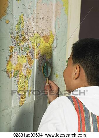 little boy holding magnifying glass against world map View Large Photo Image Picture - little boy holding magnifying glass against world map. Fotosearch