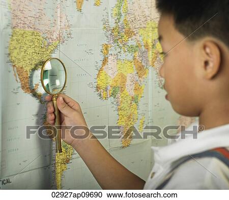 little boy holding magnifying glass against world map View Large Photo Image Stock Image - little boy holding magnifying glass against world map. Fotosearch