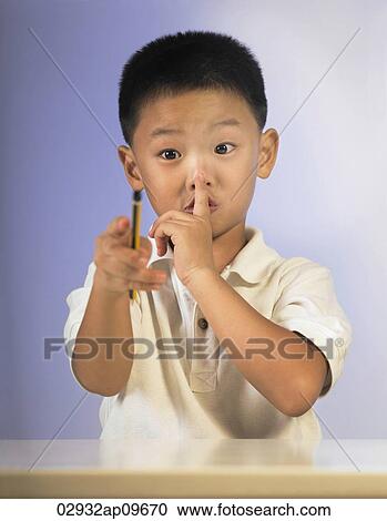little boy making keep quiet hand signals View Large Photo Image Stock Image - little boy making keep quiet hand signals. Fotosearch