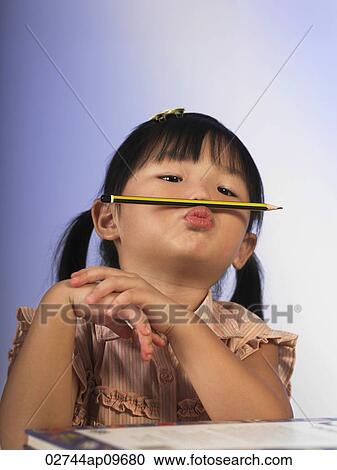 little girl balancing a pencil on her philtrum View Large Photo Image Stock Image - little girl balancing a pencil on her philtrum. Fotosearch