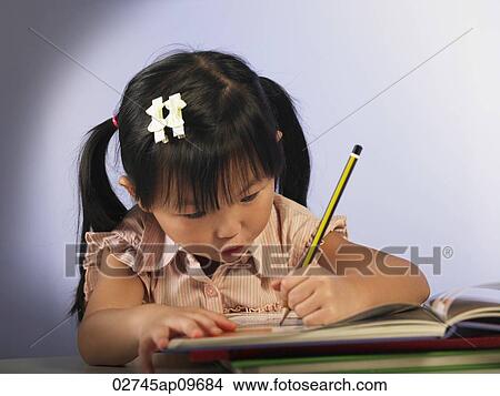 little girl reading and writing View Large Photo Image Picture - little girl reading and writing. Fotosearch