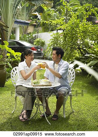 man and woman having breakfast in their garden View Large Photo Image Stock Photography - man and woman having breakfast in their garden. Fotosearch