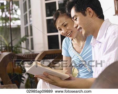 man and woman reading a book together View Large Photo Image Stock Photo - man and woman reading a book together. Fotosearch