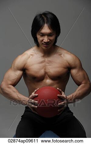 Man holding medicine ball View Large Photo Image Stock Image - Man holding medicine ball. Fotosearch