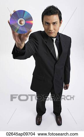 Picture - man holding up a compact disc. Fotosearch