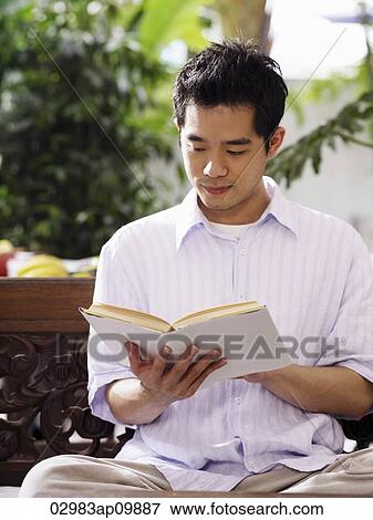 Stock Photo - man reading a book. Fotosearch