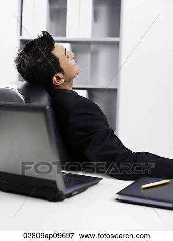 man resting in his office chair View Large Photo Image Stock Photo - man resting in his office chair. Fotosearch