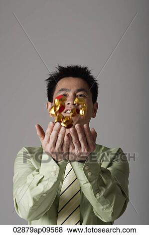 man throwing gold ingots into the air View Large Photo Image Stock Photo - man throwing gold ingots into the air. Fotosearch