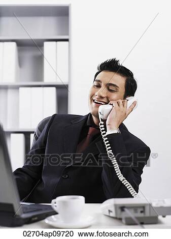 man using a office phone View Large Photo Image Stock Image - man using a office phone. Fotosearch