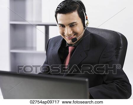 man using earphones and talking through microphone View Large Photo Image Stock Photo - man using earphones and talking through microphone. Fotosearch
