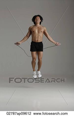 Stock Image - man working out with jump rope. Fotosearch