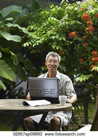 older man working on a laptop outside View Large Photo Image Stock Image - older man working on a laptop outside. Fotosearch