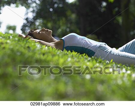 profile shot of woman laying on grass View Large Photo Image Stock Photograph - profile shot of woman laying on grass. Fotosearch