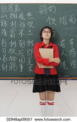 student standing in front of chinese characters written on chalk board View Large Photo Image Stock Photo - student standing in front of chinese characters written on chalk board. Fotosearch